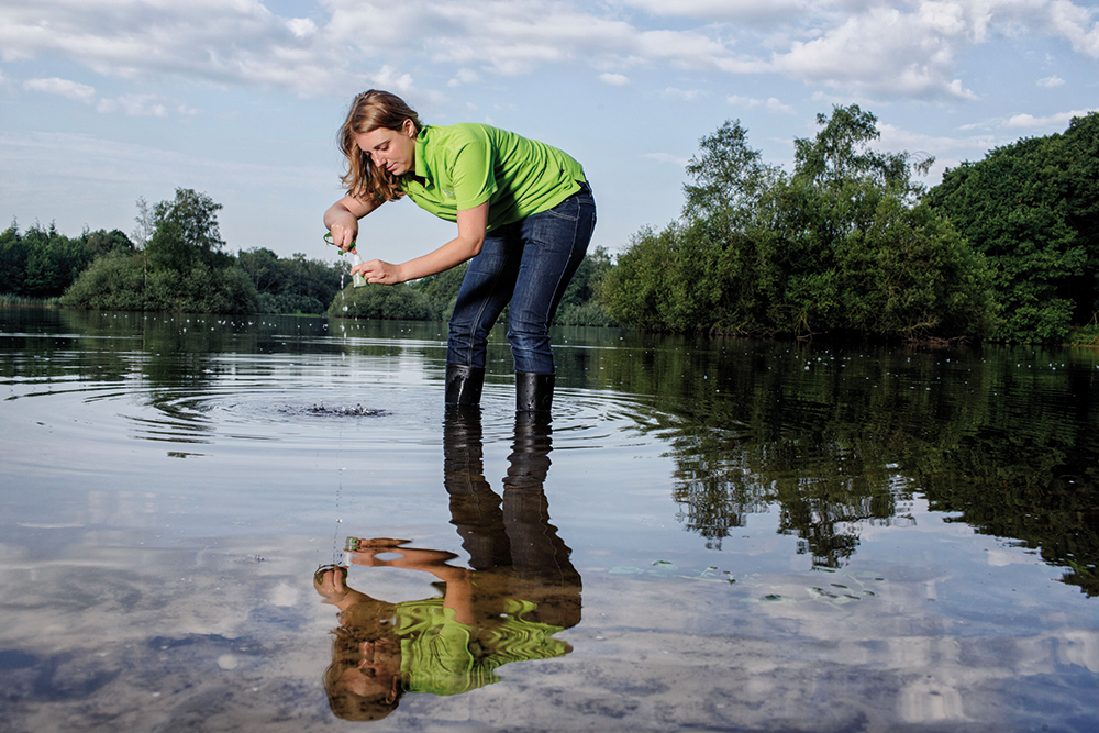 Marta Demarteau collects samples of water for analysis